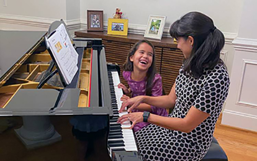 Wong and daughter playing piano