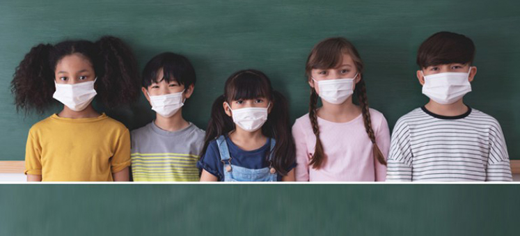 Five schoolchildren in masks
