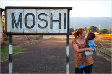 Woman holding a child at clinical research site in Moshi, Tanzania