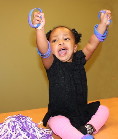 Child raising arms in air in celebration