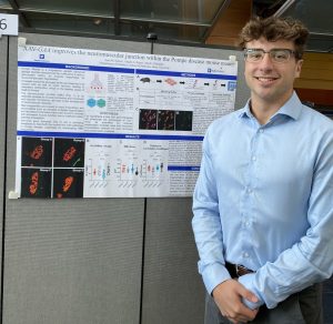 ElMallah Lab Member in front of Research Poster