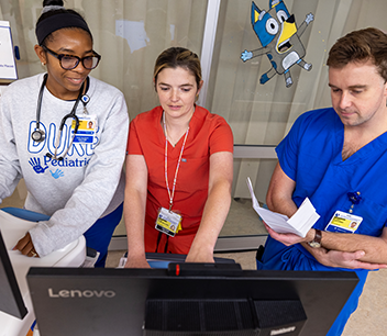 Residents with fellows looking at screen