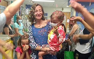 Sebastian Sancho's mother holding him at party