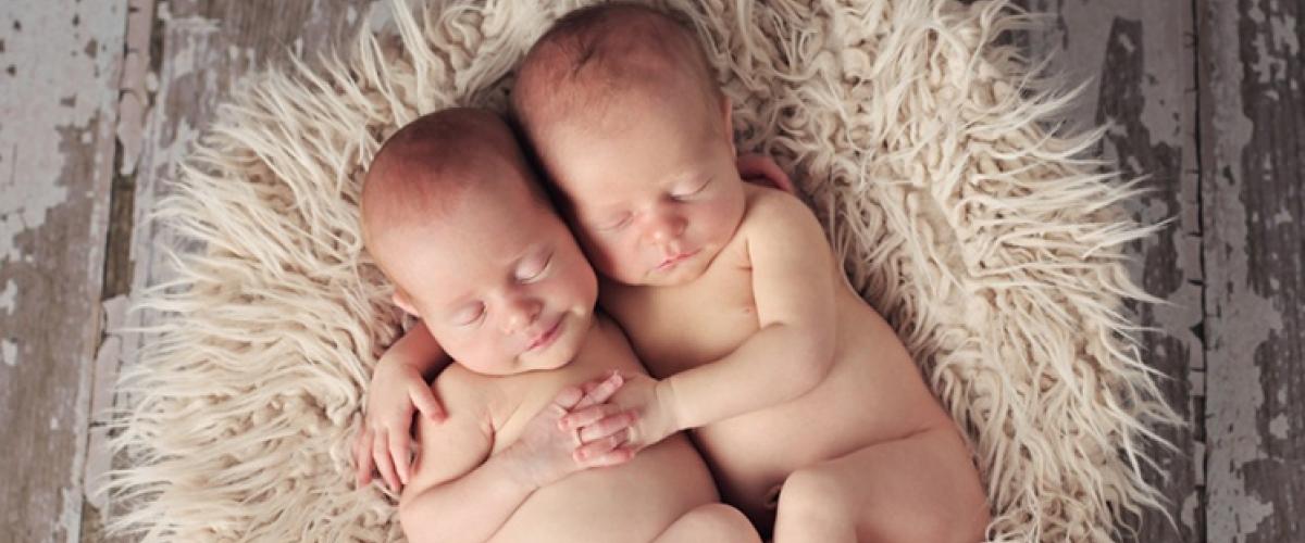 Newborn twins sleeping together