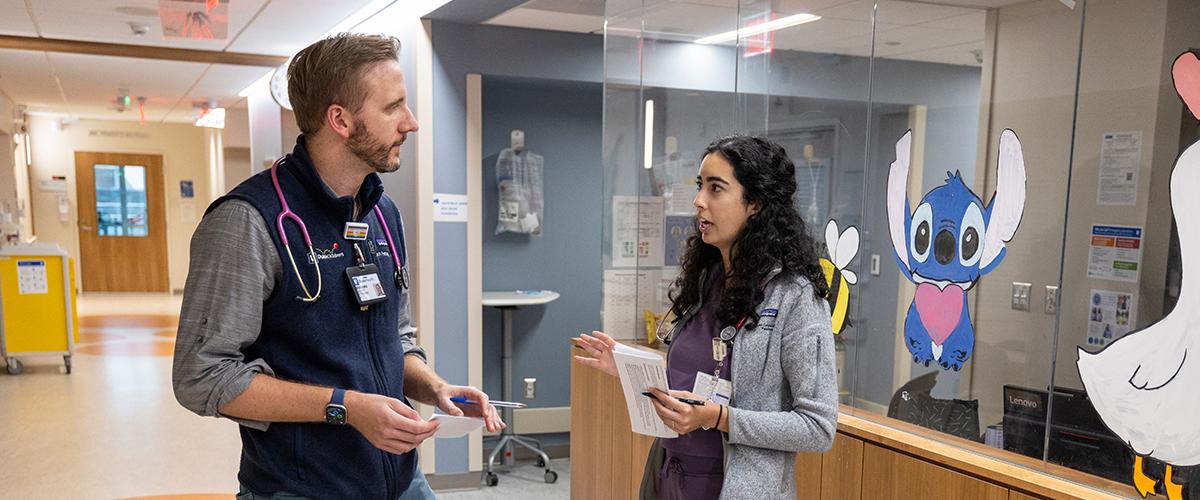 Resident Talking to Attending in Hallway