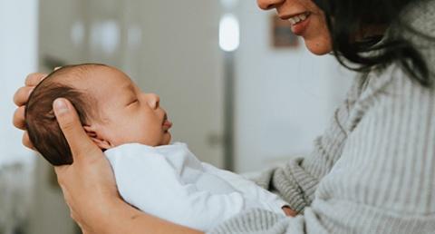 Newborn being held