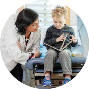Doctor reading book with child patient