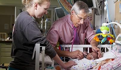 A provider attending to a newborn in the Duke Intensive Care Nursery