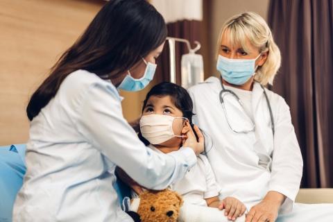 Pediatric doctors with child