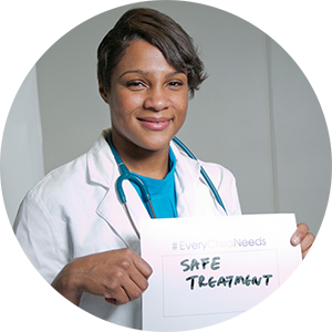 Kanecia Zimmerman holding a sign saying "Safe Treatment"