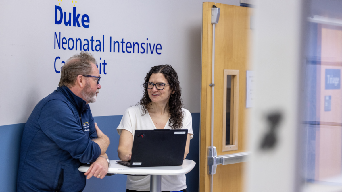 Eric Brenner, MD, PhD, and Noelle Younge, MD, MHS, talk in the Duke Hospital NICU
