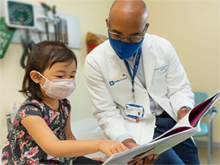 Pediatrician reading to patient