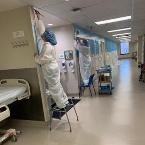 Art students installing murals in hospital