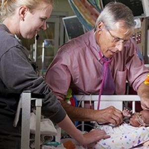 A provider attending to a newborn in the Duke Intensive Care Nursery