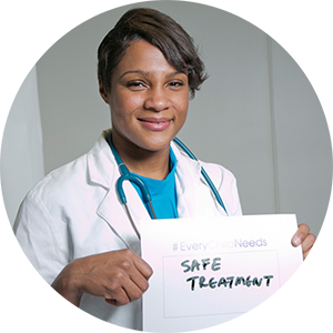 Kanecia Zimmerman holding a sign saying "Safe Treatment"
